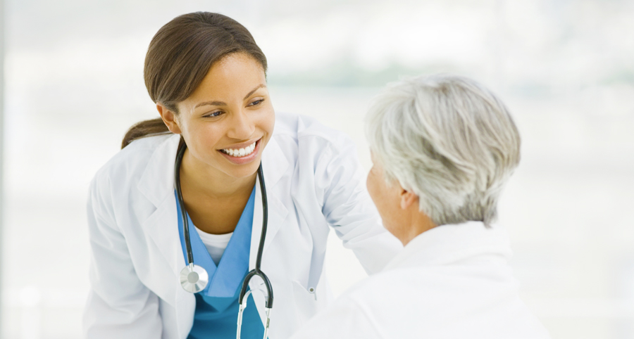 stock photo of smiling female doctor with elderly patient